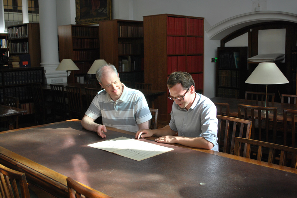 Two men studying a score in the RCM Library